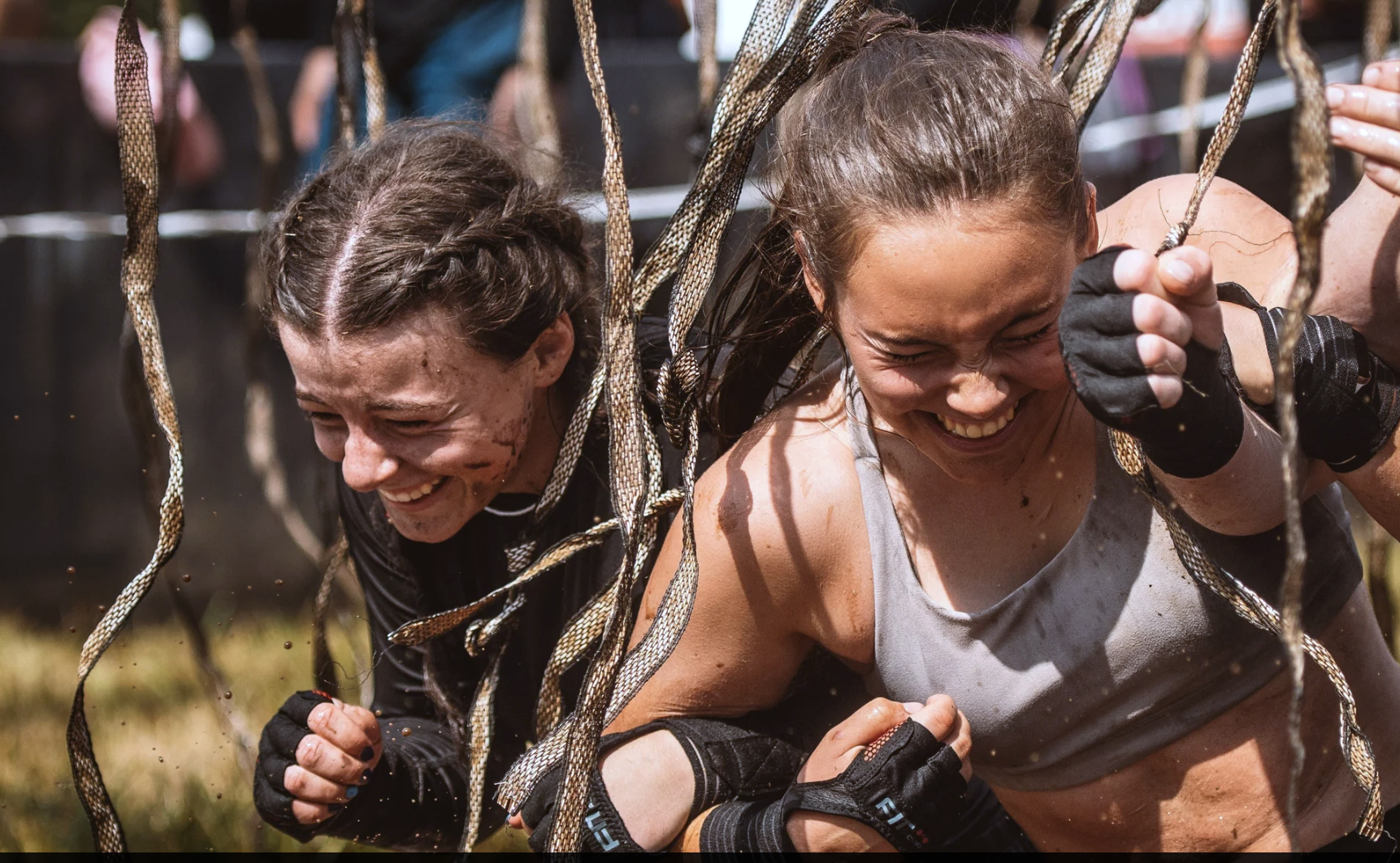 Spartan athletes climb a wall during a race.